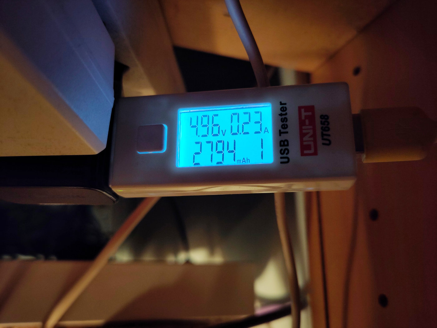 A photo showing a USB power meter. The statistics on the meter's LCD screen
say: 4.96V, 0.23A, 2794mAh, channel 1.